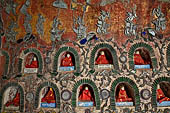 Myanmar, Burma, Nyaungshwe. Small Buddhas set into the temple wall, Shwe Yaunghwe Kyaung monastery, near Inle Lake.